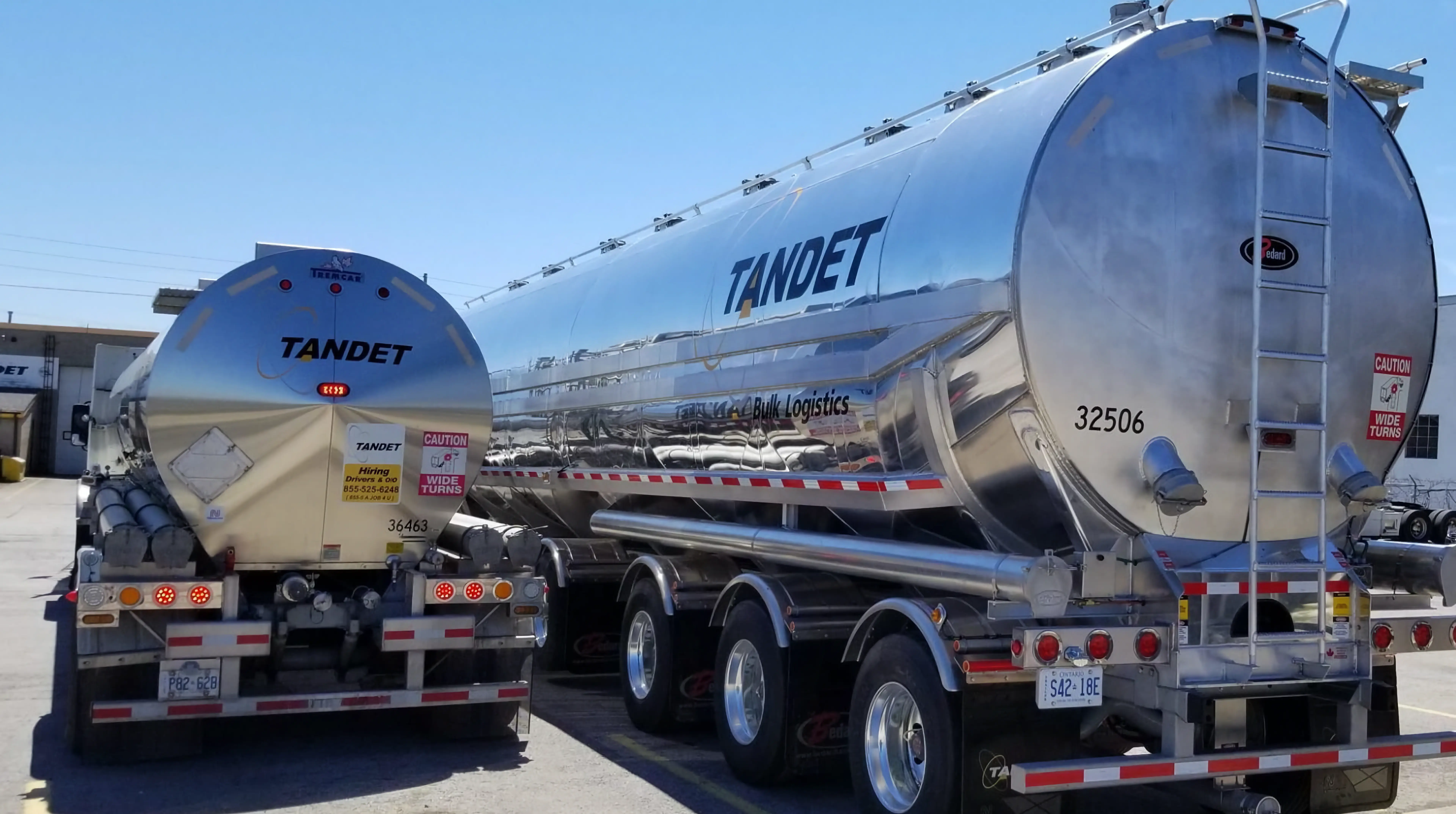 TANDET stainless steel tanker trailers parked at a logistics yard in Canada.