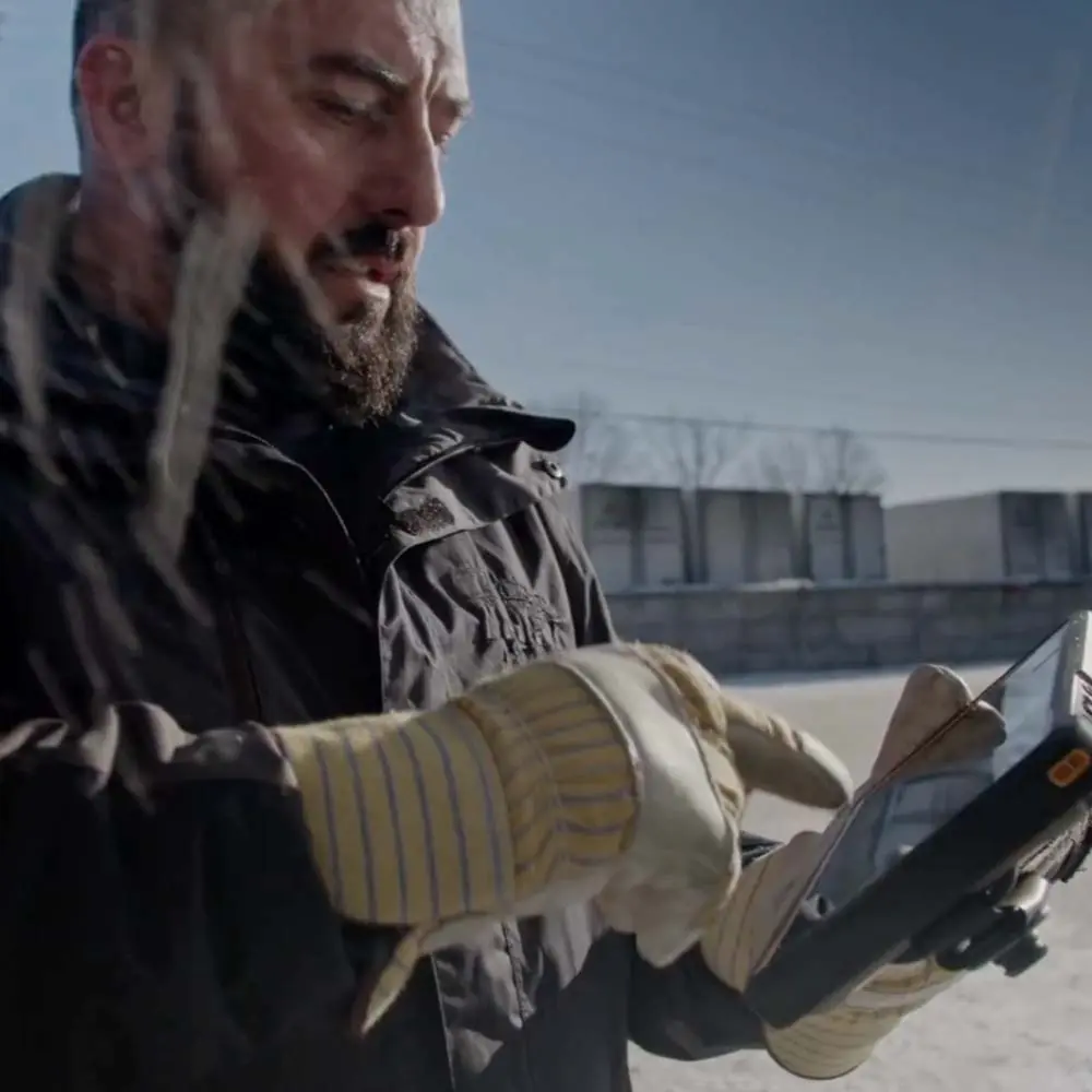 Trucking professional using ISAAC tablet in cold weather with gloves