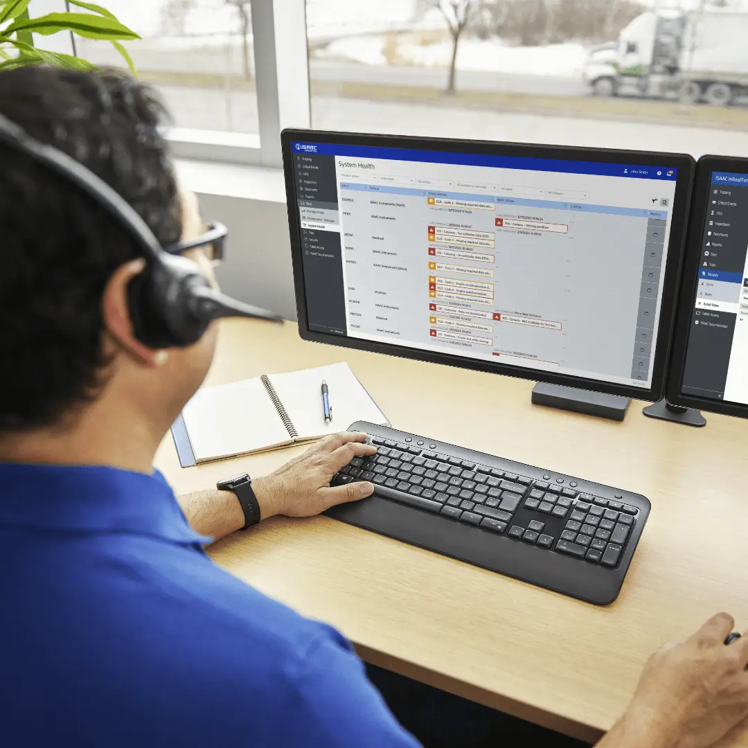 Office Staff Using Fleet Management Software Office staff using ISAAC fleet management software on a computer.