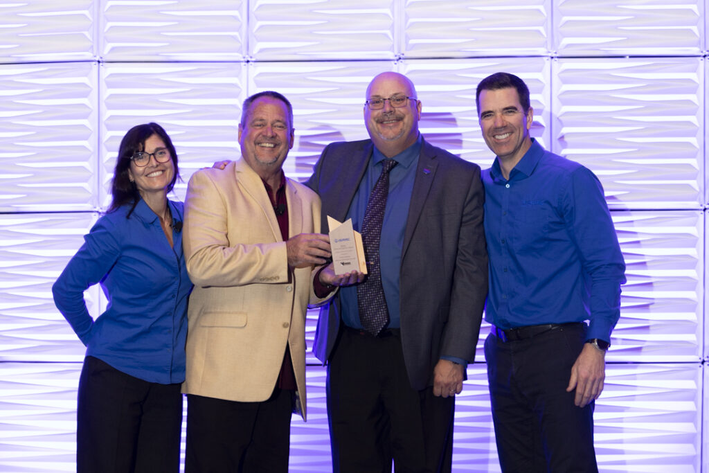 Guy Broderick from Kriska receiving the Safety & Compliance Award at ISAAC HORIZON 2024, with ISAAC CEO Jacques DeLarochelliere and Jim Angel of Speedgauge.
