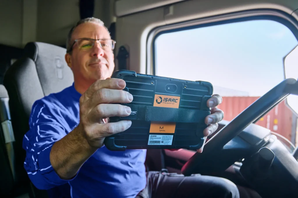 Truck Driver Holding an ISAAC ELD Device
