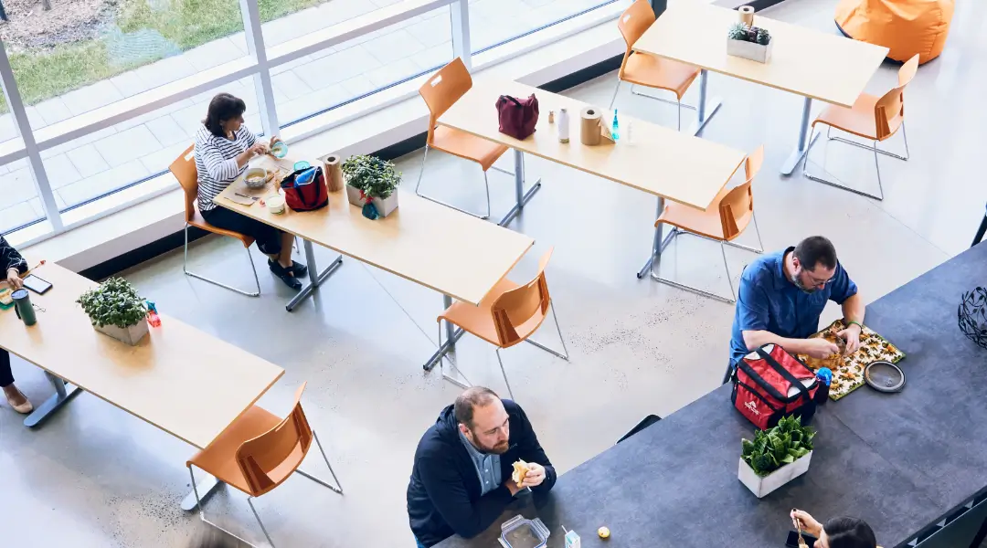 A Welcoming Lunchtime at ISAAC Instruments Employees seated in a bright, modern cafeteria space at ISAAC Instruments