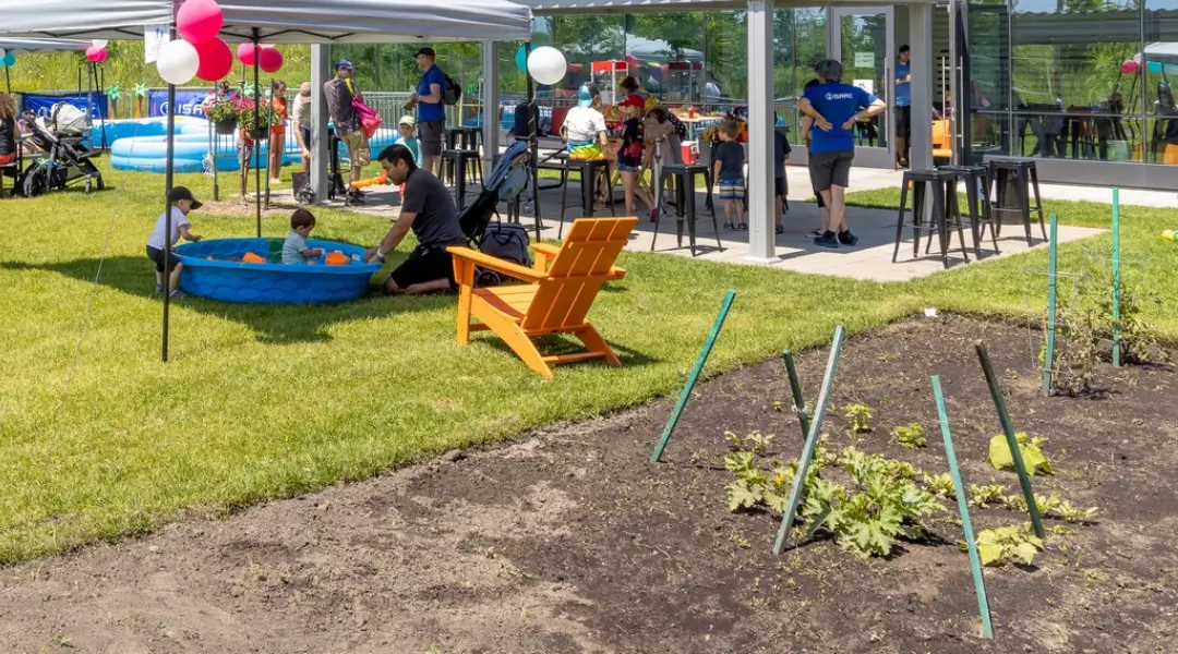 Summer Celebration at ISAAC Instruments: Fun for the Whole Family Parents and children enjoying outdoor games and a small pool at an ISAAC Instruments company event