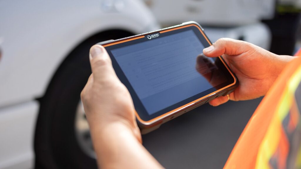 Close-up of ISAAC's rugged in-cab tablet used by a driver for DTTS-certified military freight tracking