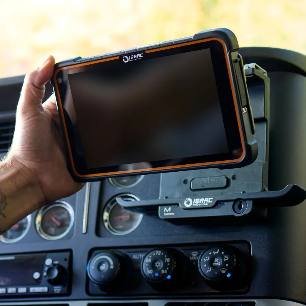 Technician Mounting ISAAC InControl Device in Truck Hand installing ISAAC InControl ELD device into truck dashboard mount