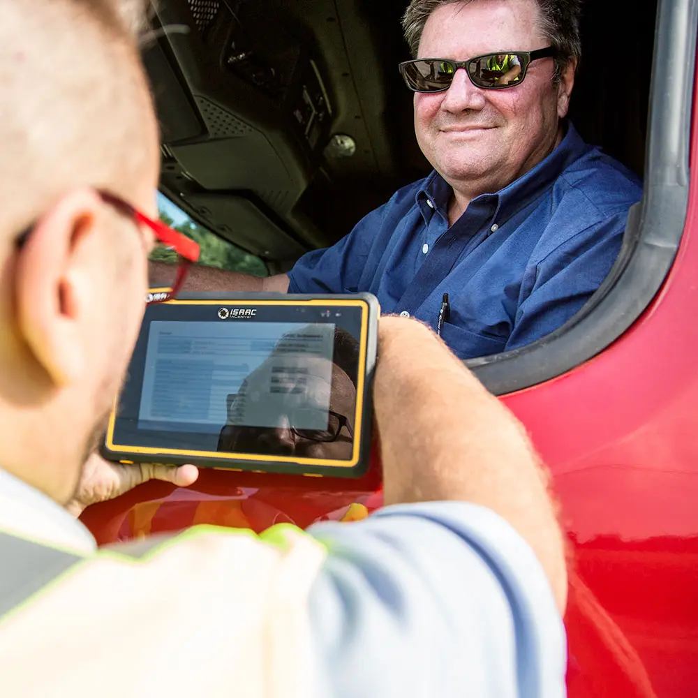 Simplified Compliance Through Fleet Dashboards Truck driver accessing compliance tracking features on a mounted fleet tablet