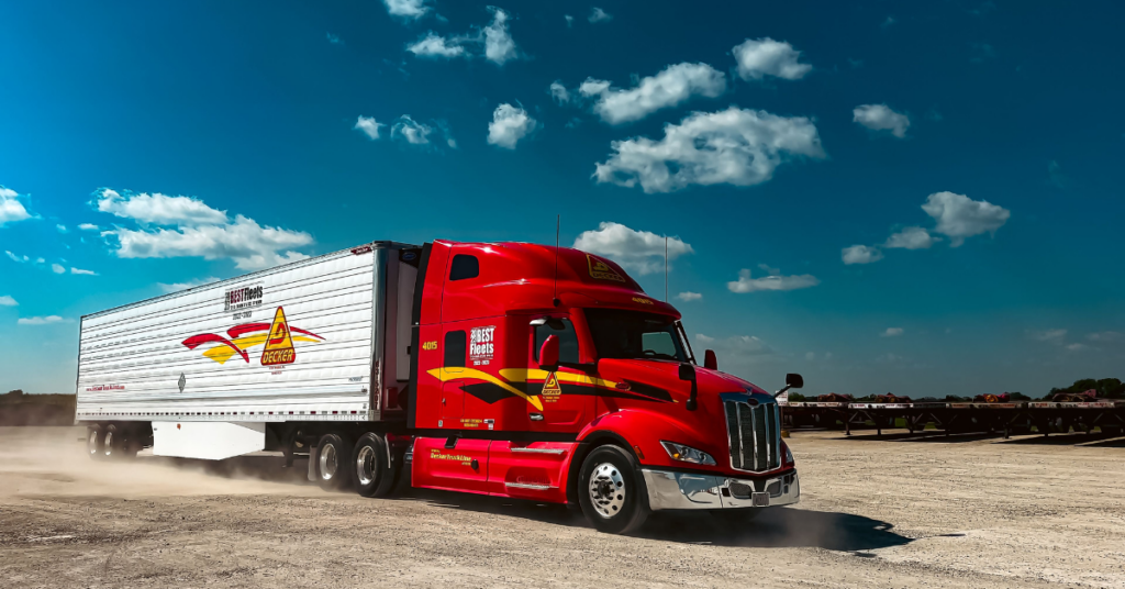 A red Decker Truck Line semi-truck operating with ISAAC's fleet management platform to enhance in-cab technology and ensure ELD compliance.