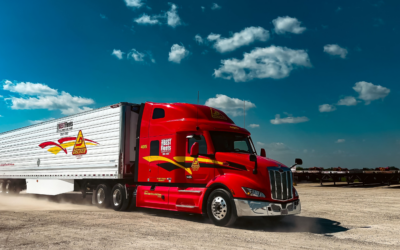 A red Decker Truck Line semi-truck operating with ISAAC's fleet management platform to enhance in-cab technology and ensure ELD compliance.