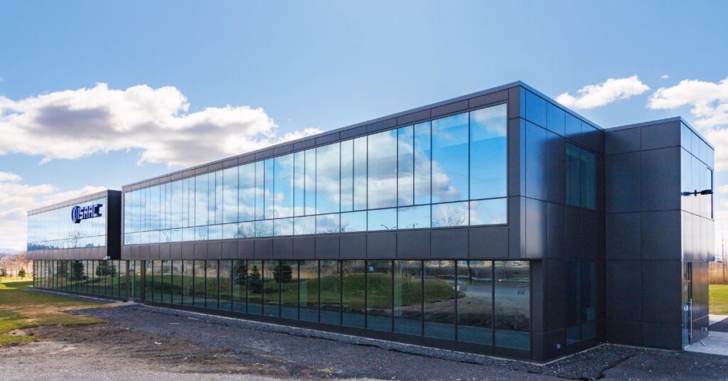 Modern glass exterior of ISAAC Instruments' expanded 52,000-square-foot headquarters in the Saint-Bruno-de-Montarville Ecopark, symbolizing the company's local innovation and AI leadership in the trucking industry.